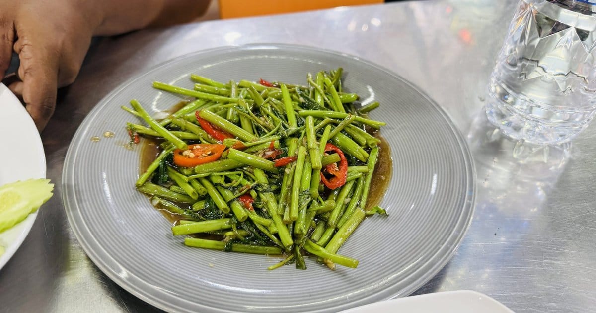 A plate of stir-fried vegetables with red chili peppers