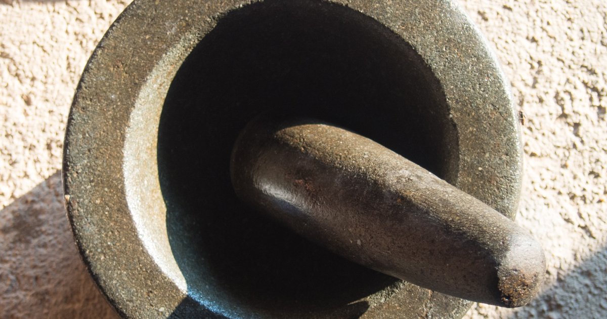 A stone mortar and pestle used for grinding herbs