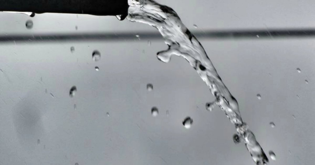 Water splashing from a bathroom faucet, close up
